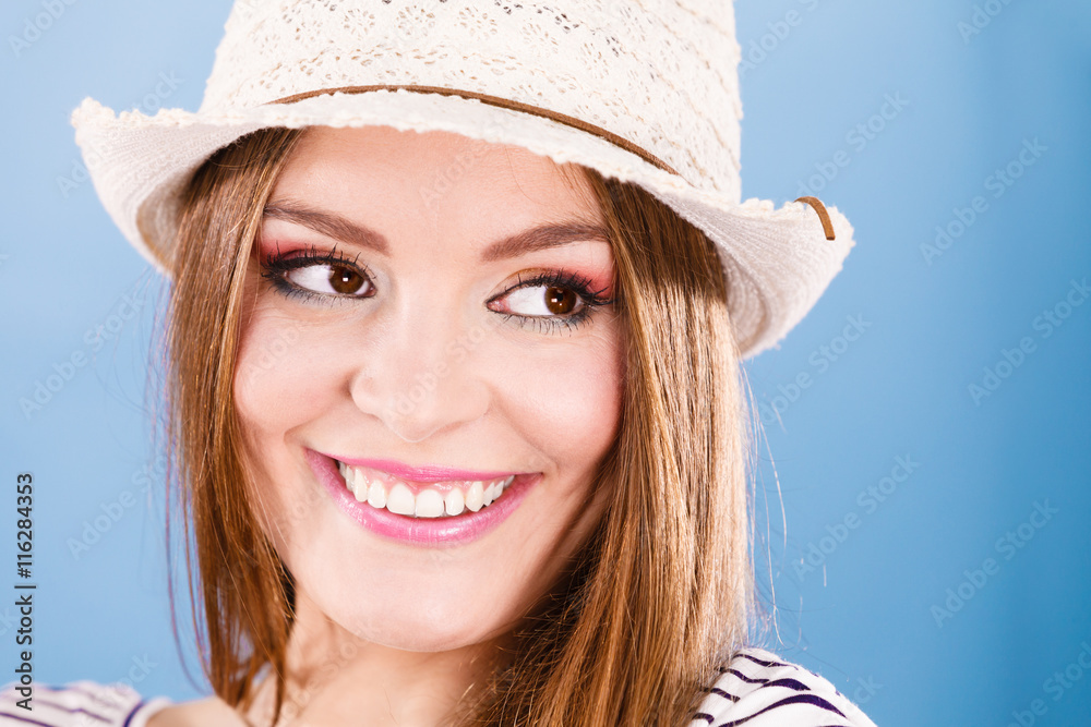 Woman face colorful eyes makeup, summer straw hat smiling Woman face colorful eyes makeup, summer straw hat smiling