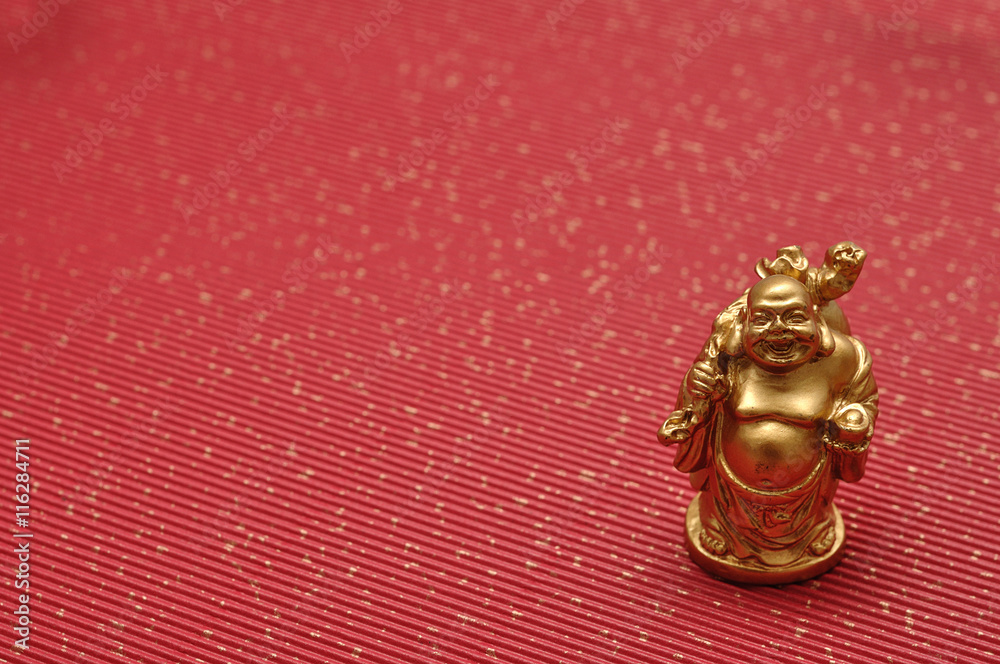 Figurine of laughing and cheerful golden Buddha Figurine of laughing and cheerful golden Buddha