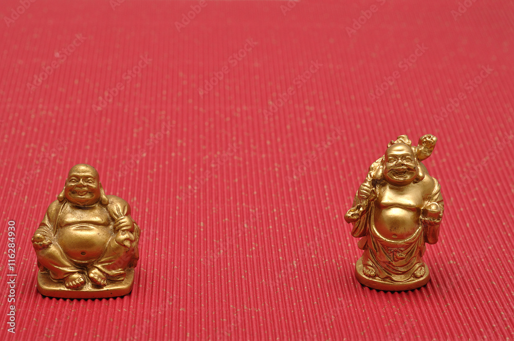 Row of Figurines of laughing and cheerful golden Buddhas Row of Figurines of laughing and cheerful golden Buddhas