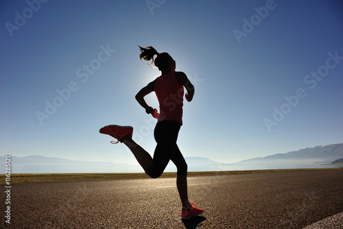 healthy lifestyle young woman runner running on sunrise seaside