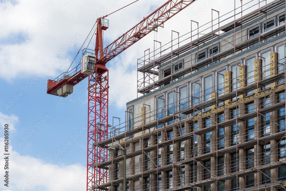 scaffolding and crane on building facade