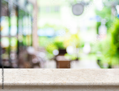 Empty luxury white marble table top with blurred cafe bokeh ligh