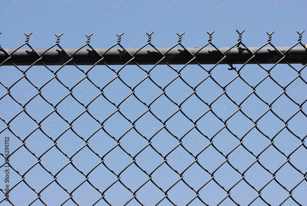iron chainlink fence against sky iron chainlink fence against sky