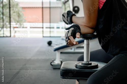 athletic young woman doing a fitness workout with dumbbell