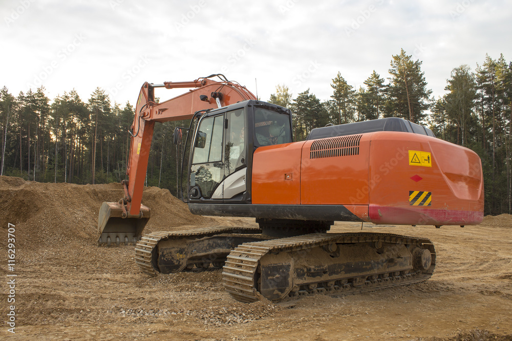 a large excavator is preparing the site for construction of a ne a large excavator is preparing the site for construction of a ne