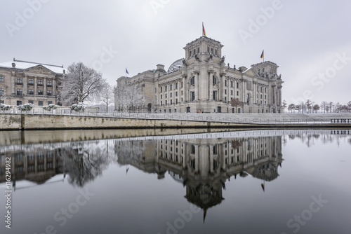 Reichstag building (Bundestag) and with reflection in river Spree in Winter, Berlin government district, Germany, Europe