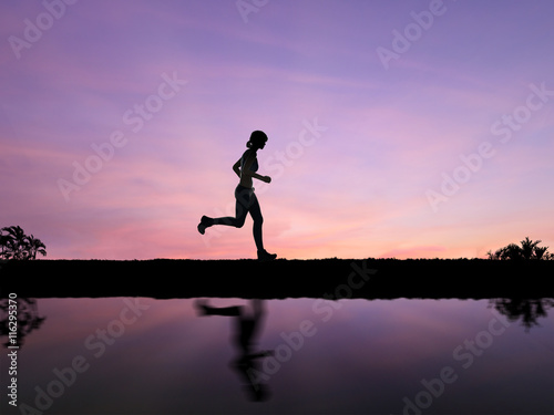 Fototapeta Naklejka Na Ścianę i Meble -  silhouette woman running on twilight background