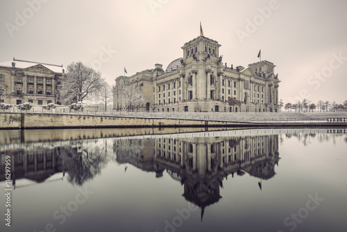 Canvas Print Reichstag building (Bundestag) and with reflection in river Spree in Winter, Ber