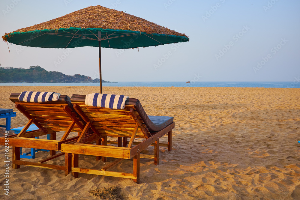 empty beach chairs on a tropical beach