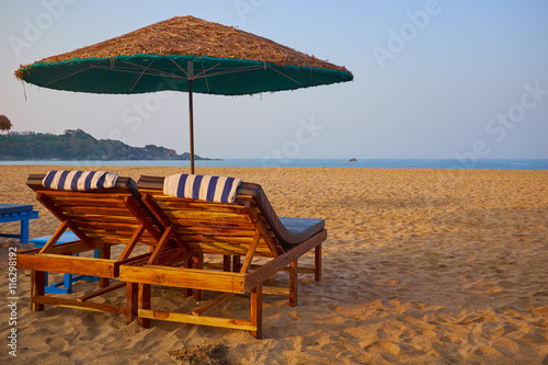Fototapeta Naklejka Na Ścianę i Meble -  empty beach chairs on a tropical beach