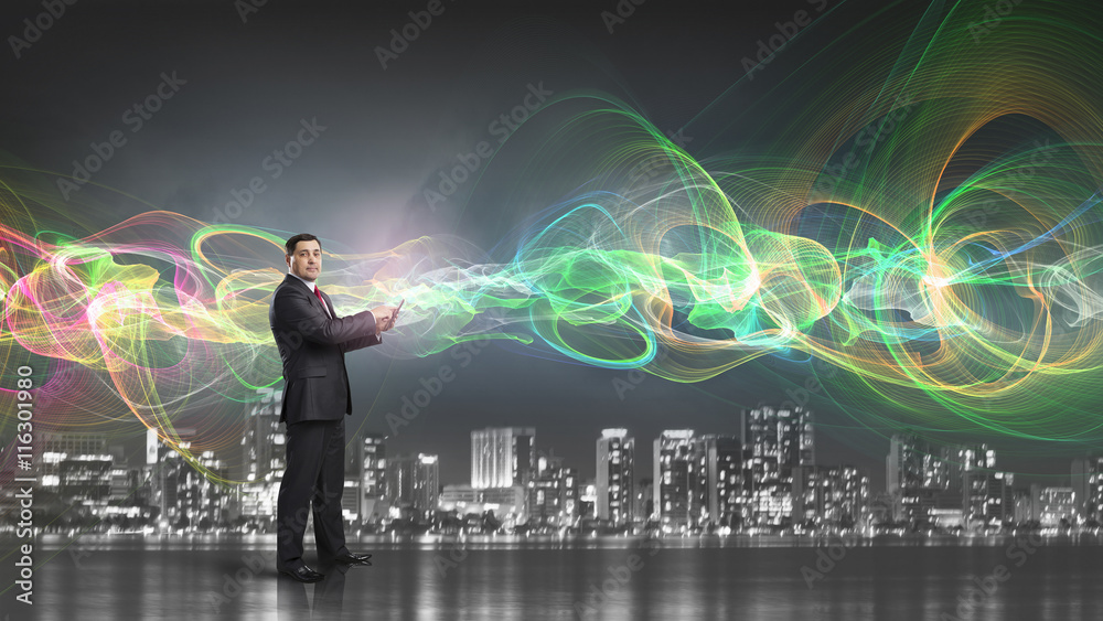 Businessman use tablet pc . Mixed media Businessman use tablet pc . Mixed media