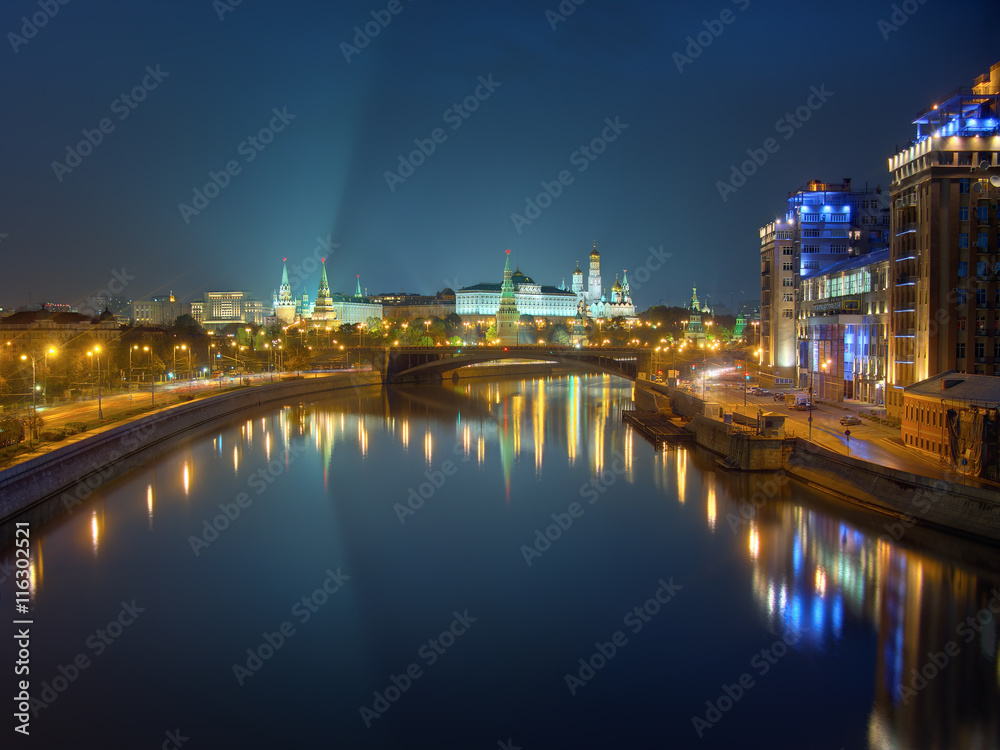 Moscow Kremlin at night, view from bridge across the river. Peaceful night scene: clear sky and city lights reflected in calm water. High dynamic range photo, combined from 6 different exposures.