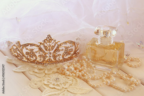 White pearls necklace, diamond tiara and perfume bottle