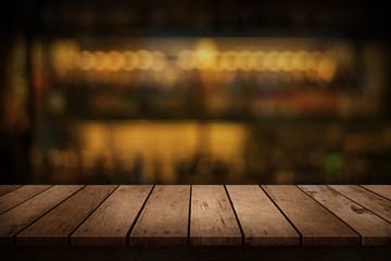 wooden table with a view of blurred beverages bar backdrop