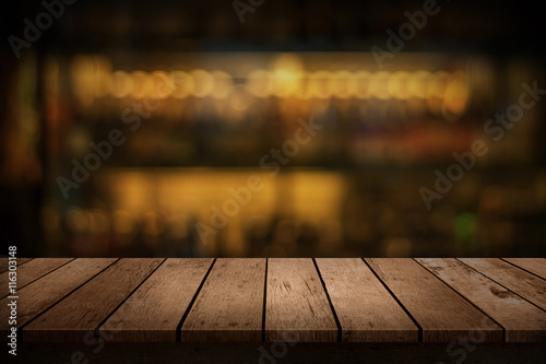 wooden table with a view of blurred beverages bar backdrop