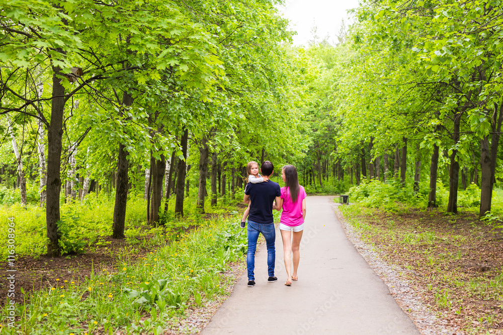 Happy young family walking in green nature. Happy young family walking in green nature.