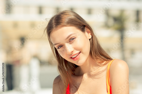 Beautiful woman have sunbath and relaxing near pool