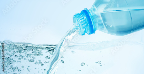 close up of water pouring from plastic bottle
