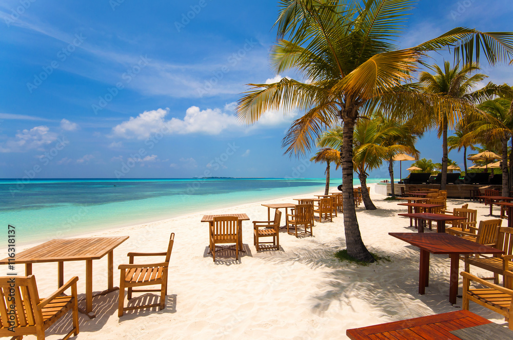 Cafe on the beach, ocean and sky - wonderful landscape of Maldives