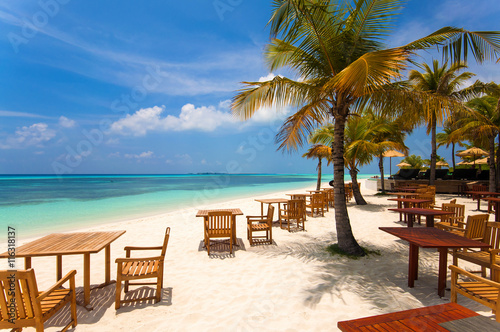 Cafe on the beach, ocean and sky - wonderful landscape of Maldives © donvictori0