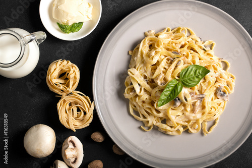 Принти на полотні Pasta with mushrooms and bechamel sauce on the chalkboard