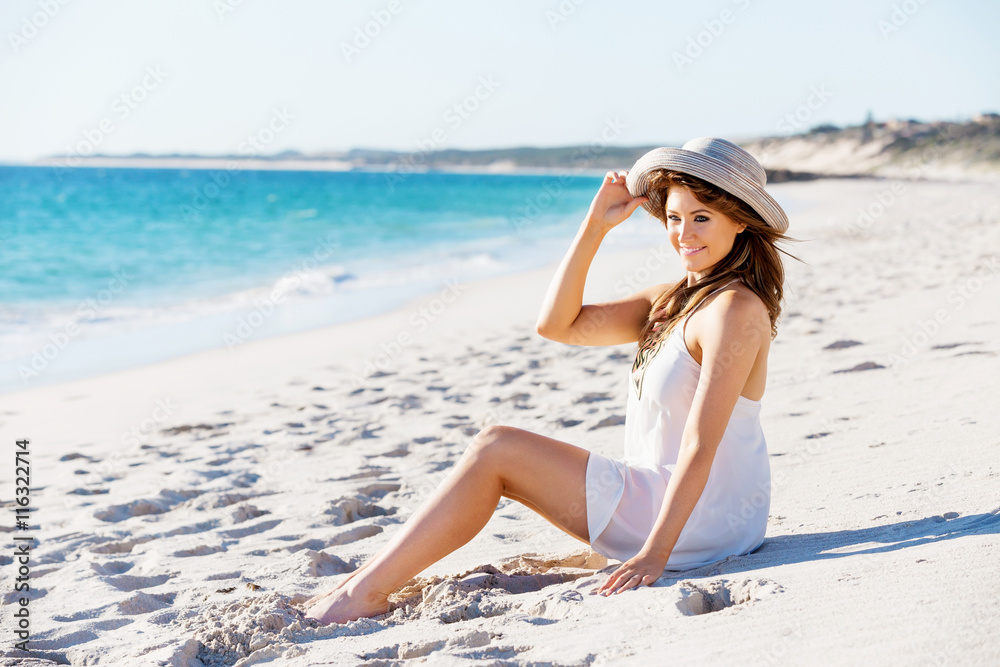 Young woman sitting on the beach Young woman sitting on the beach