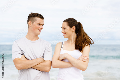 Young couple looking at each other on beach