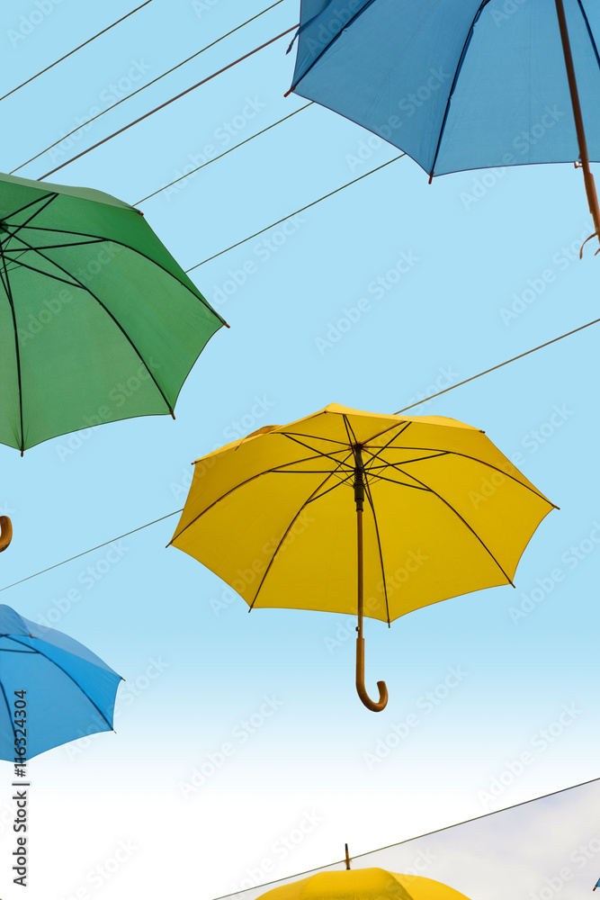 Multicolor umbrellas in blue sky