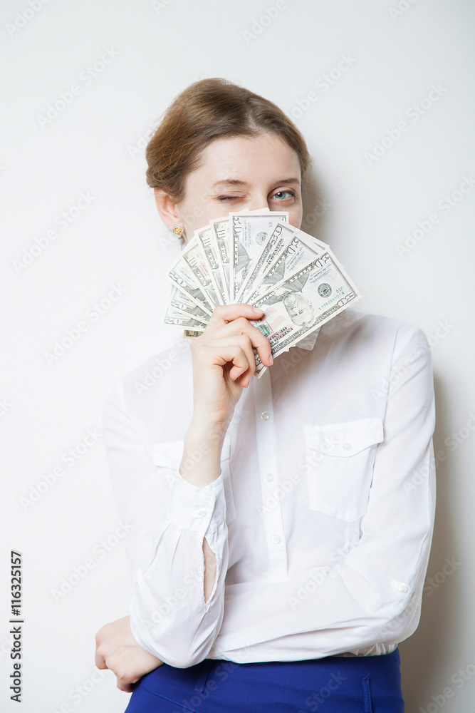 Beautiful playful businesswoman winking and holding dollars Beautiful playful businesswoman winking and holding dollars