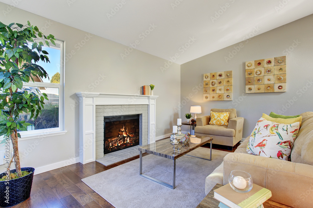 Cozy living room with hardwood floor and fireplace Cozy living room with hardwood floor and fireplace