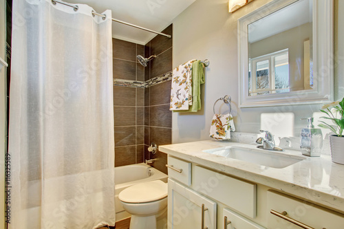 Bathroom interior with white cabinets  tile floor
