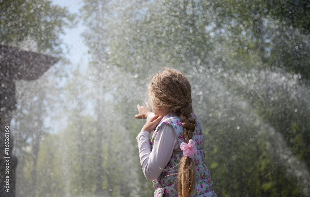 little girl playing near the fountain little girl playing near the fountain