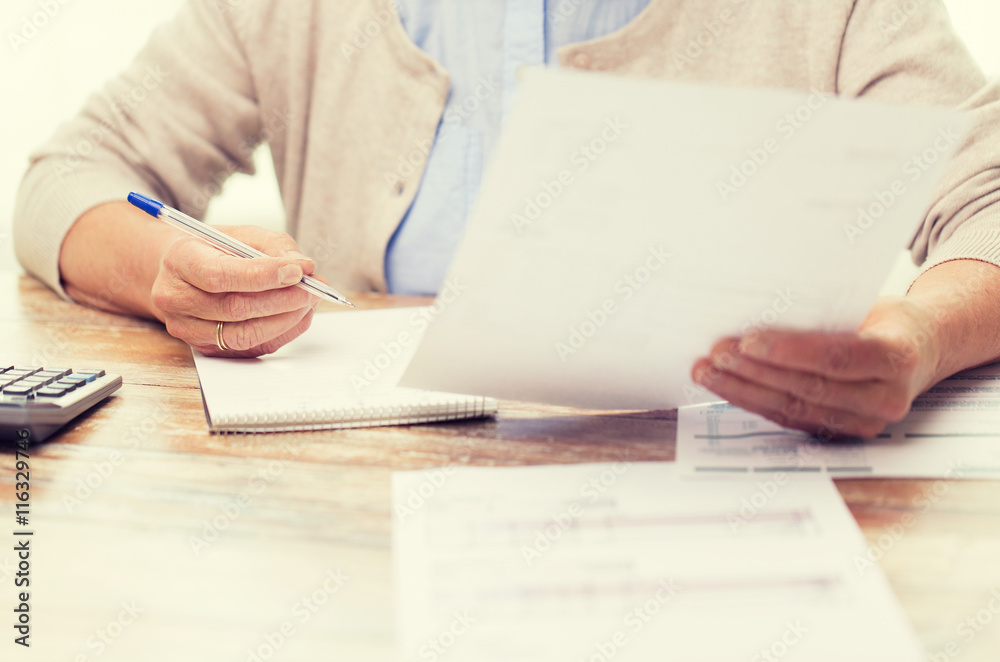 © Syda Productions - senior woman with papers and calculator at home