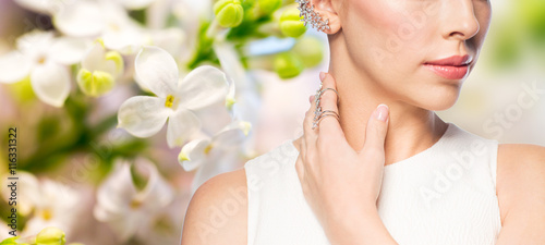 close up of beautiful woman with ring and earring