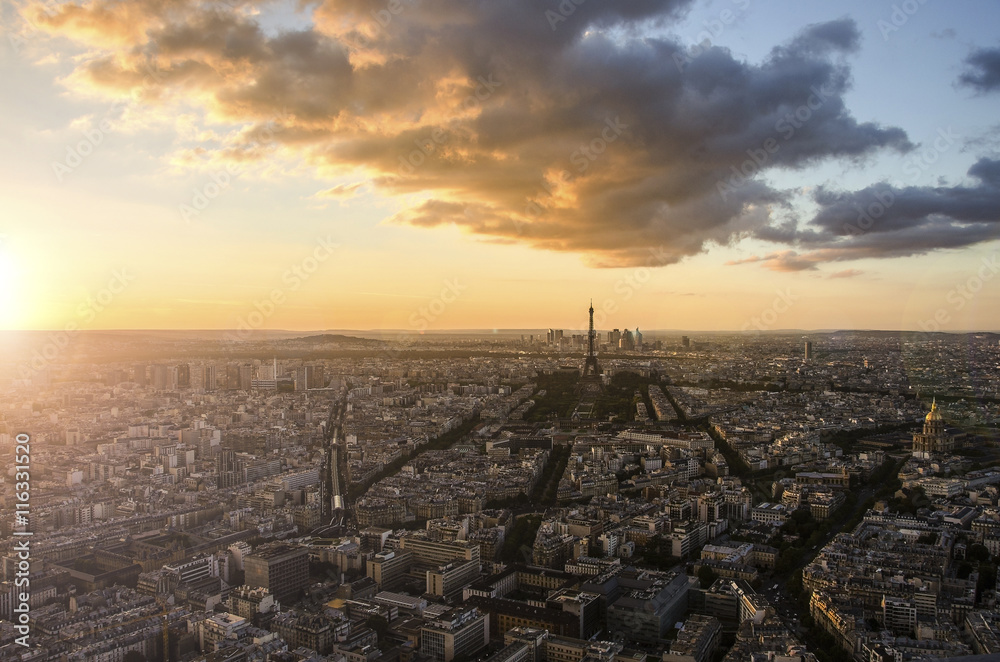 Eiffel Tower and Paris cityscape from above in orange sunset sunlight, France