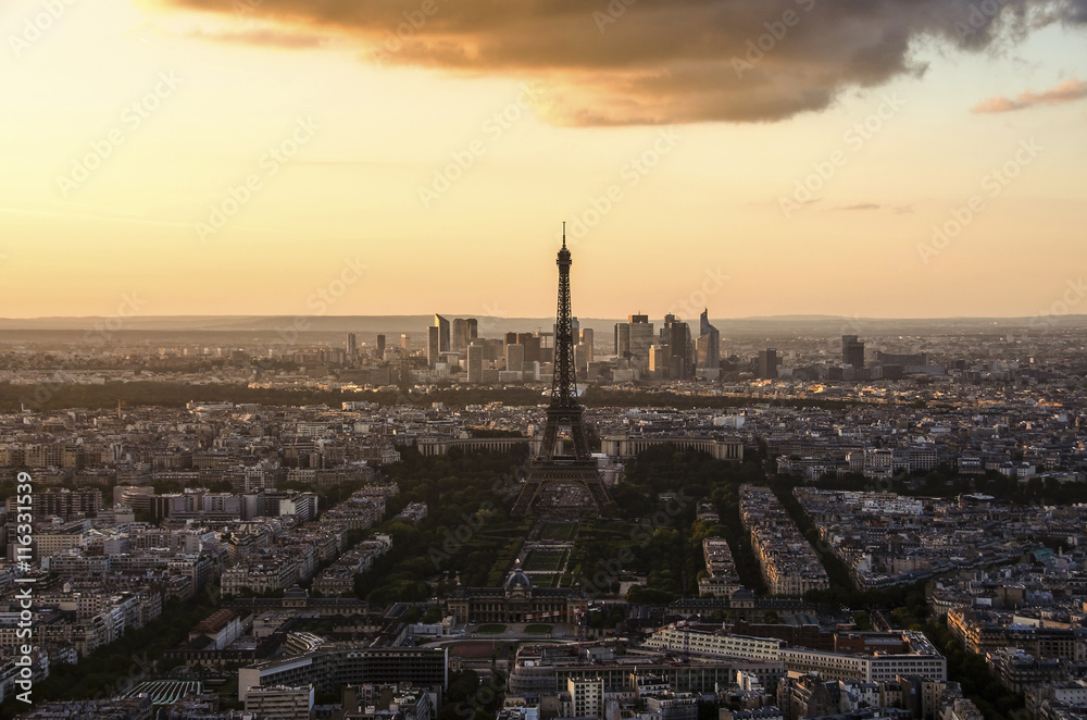 Eiffel Tower and Paris cityscape from above in orange sunset sunlight, France