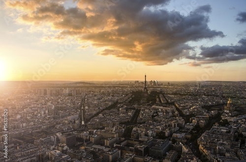 Eiffel Tower and Paris cityscape from above in orange sunset sunlight, France © Mariana Ianovska