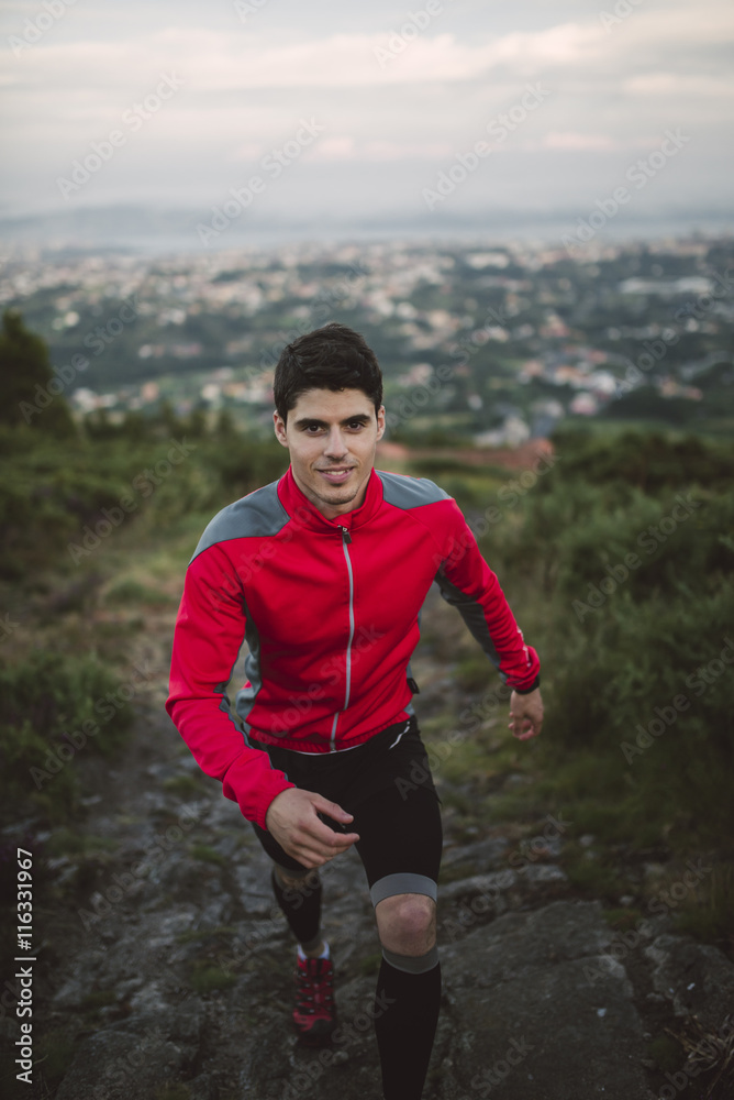 Trail runner man training in nature in the evening Trail runner man training in nature in the evening