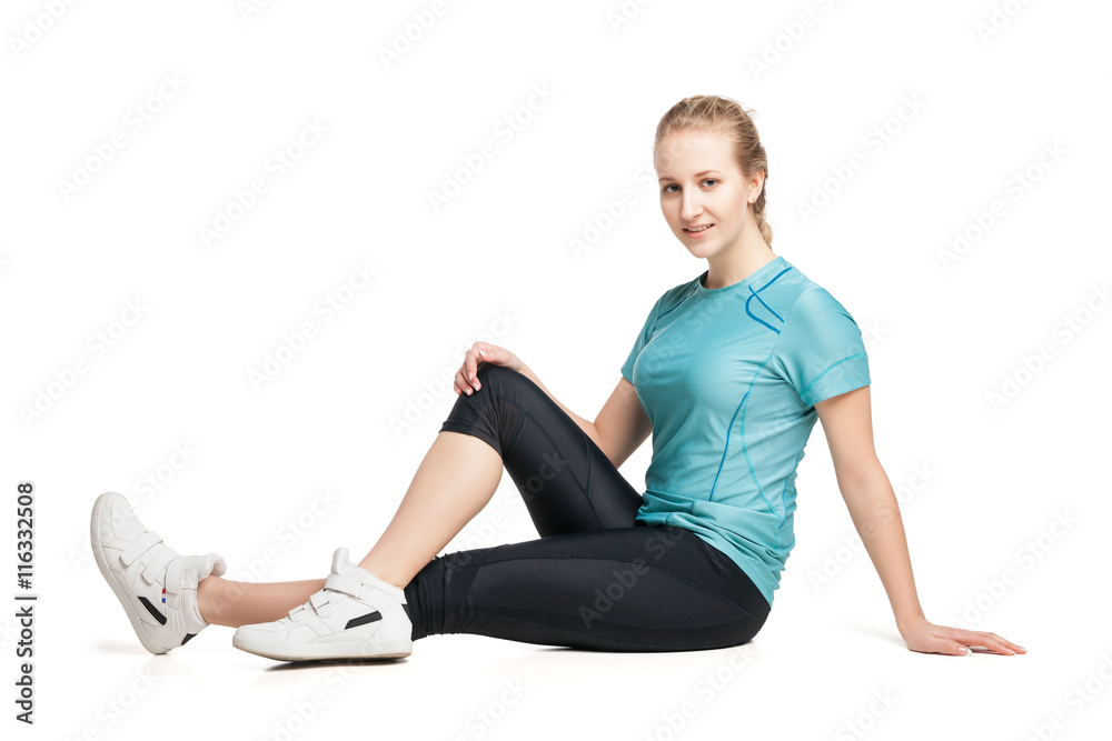 Beautiful sporty woman sitting on the floor Beautiful sporty woman sitting on the floor