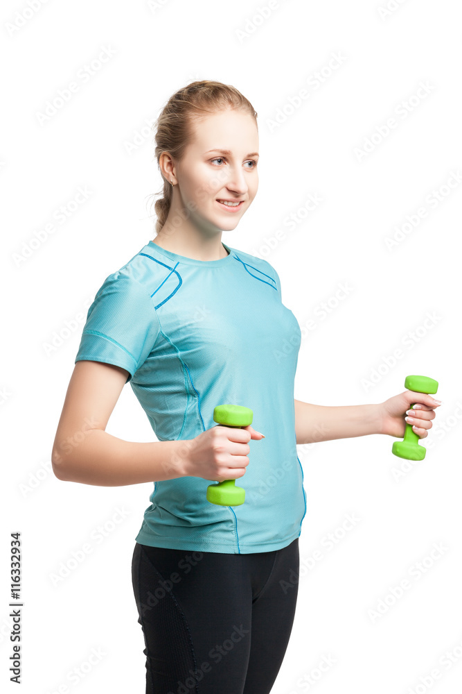 Naklejka premium Athletic young woman works out with green dumbbells
