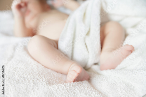 newborn tiny baby lying on the bed with blanket © julenochek