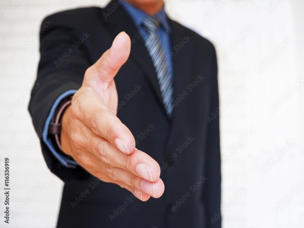 selective focus of businessman giving his hand for handshake, business concept