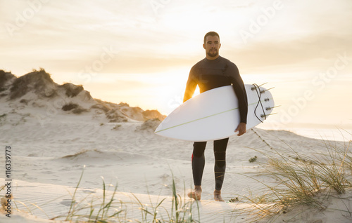 A surfer with his surfboard