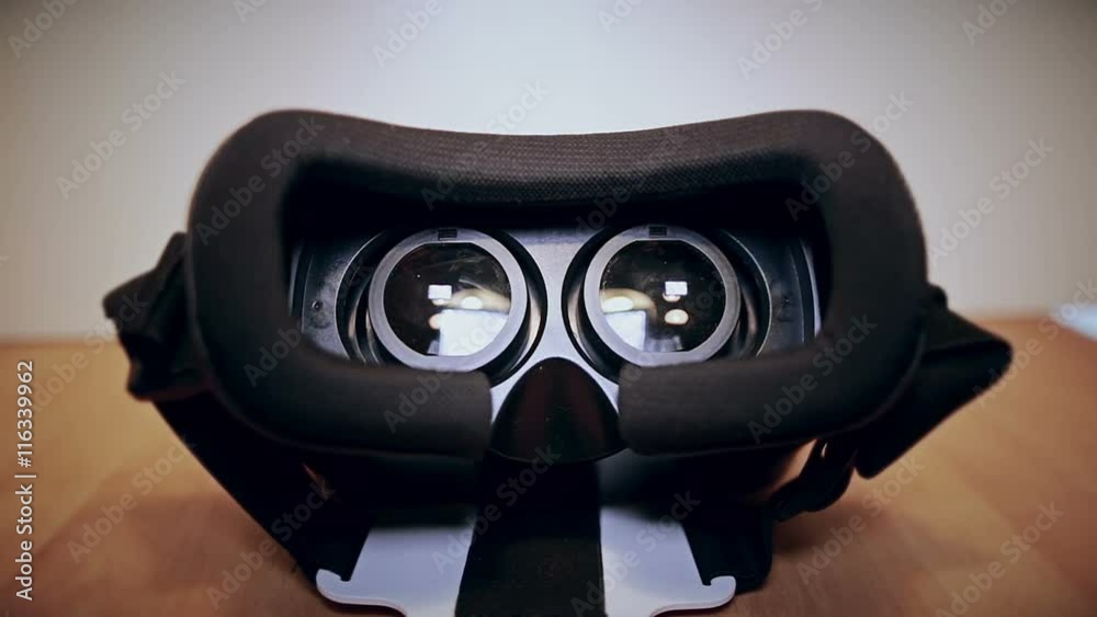 Camera moves slow around virtual reality glasses, vr, lying on the table, view from different sides