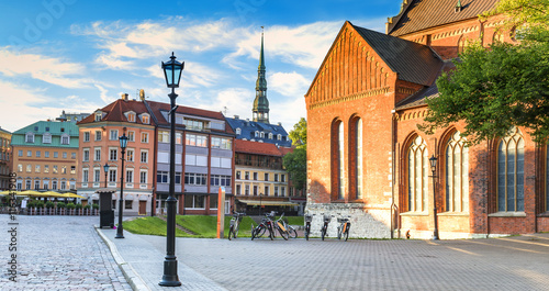 Central square of the old Riga city with building of church of the Dome Cathedral and view on a spire of the church of Saint Peter, Latvia