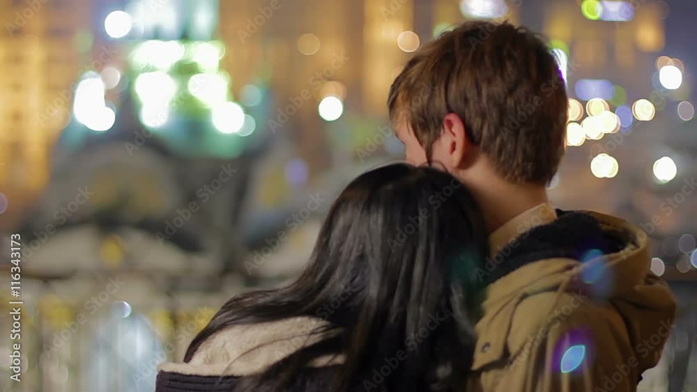 Loving couple hugging each other and enjoying beautiful night city view, love Loving couple hugging each other and enjoying beautiful night city view, love