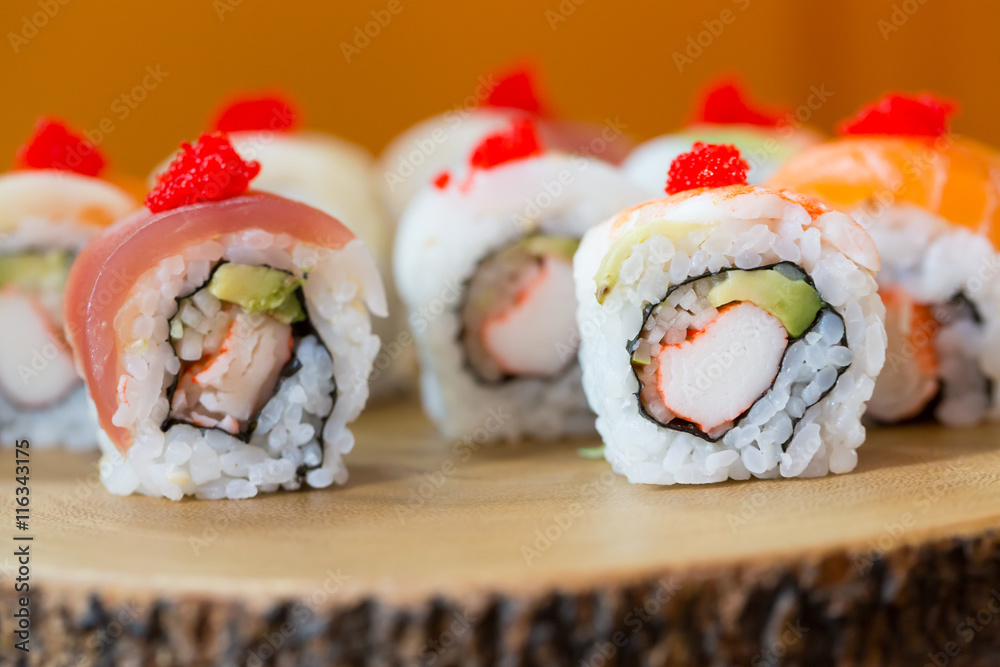 Sushi set, sushi roll with salmon and sushi roll with avocado. Sushi set, sushi roll with salmon and sushi roll with avocado.