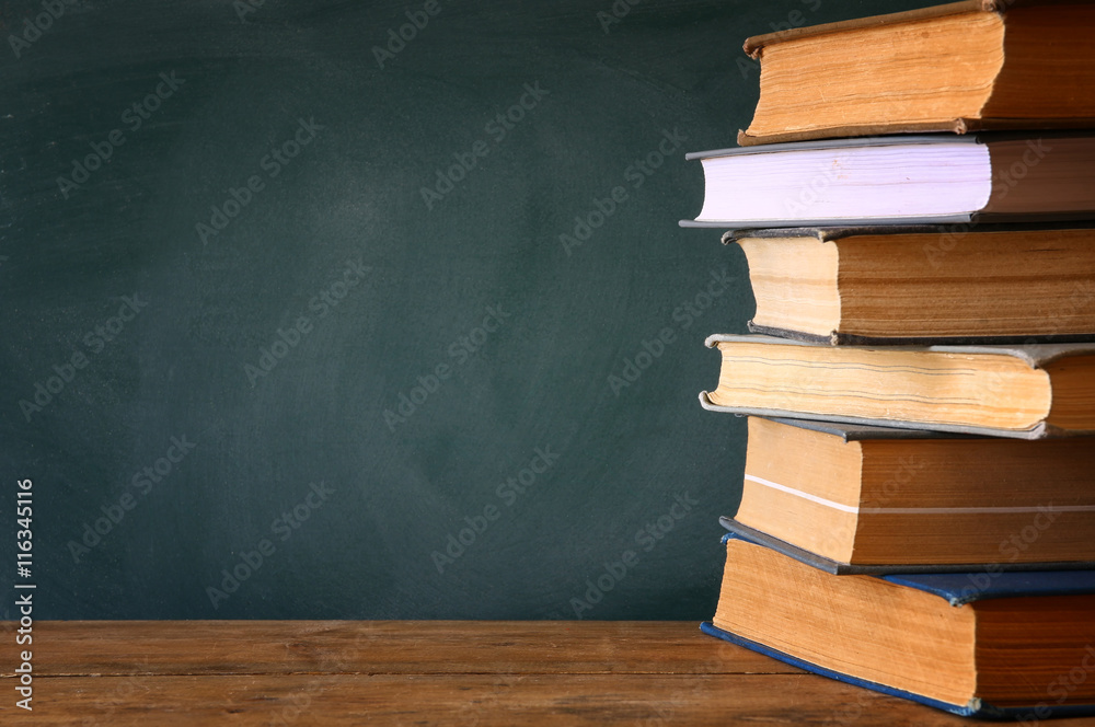 Back to school concept. Blackboard with stack of books Back to school concept. Blackboard with stack of books