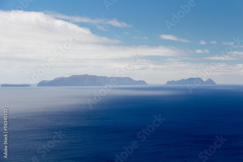 Islands (Ilhas Desertas) in the east of Madeira, named Chao, Deserta Grande and Bugio, view from Machico, Madeira, Portugal photo