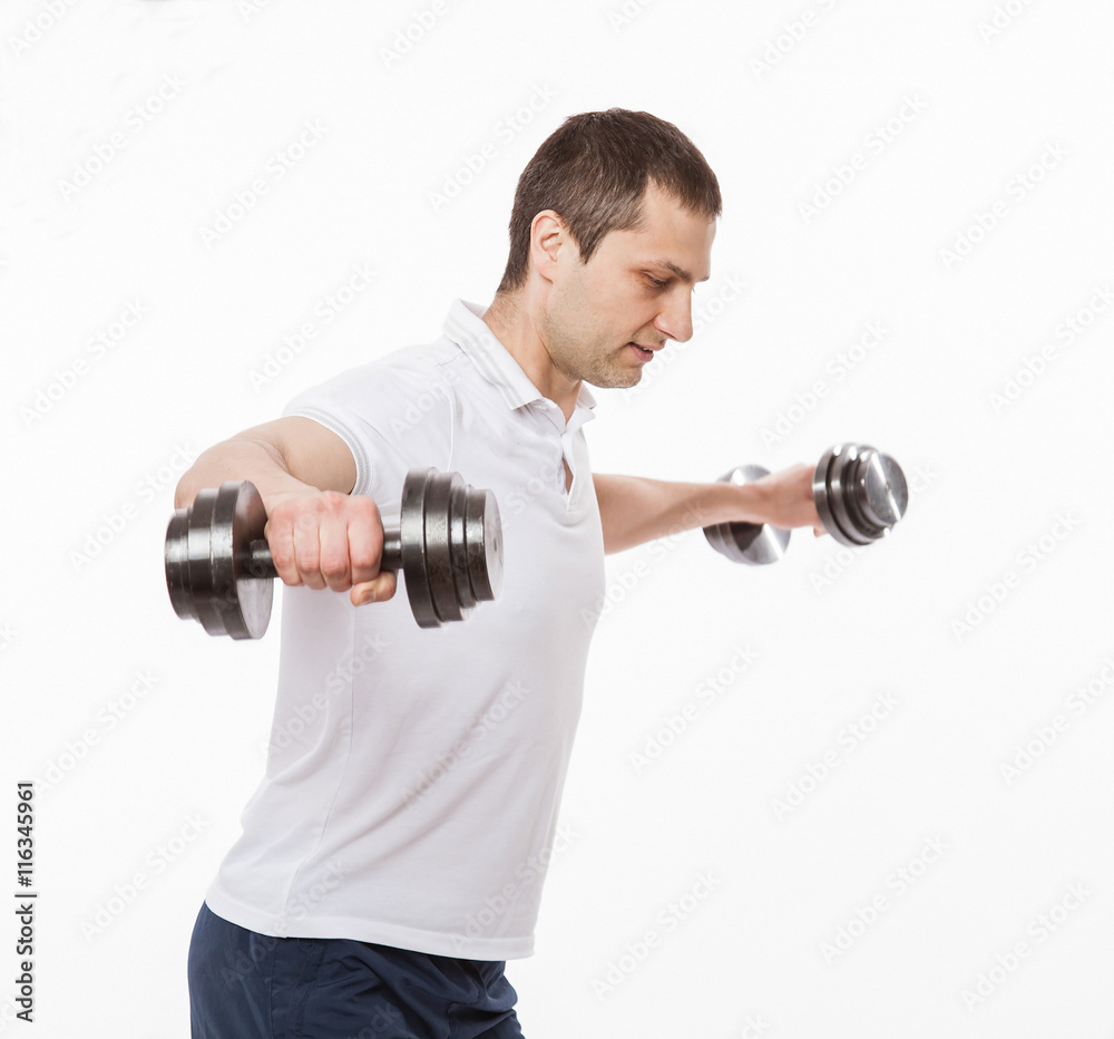 Young man doing exercises with dumbbells Young man doing exercises with dumbbells